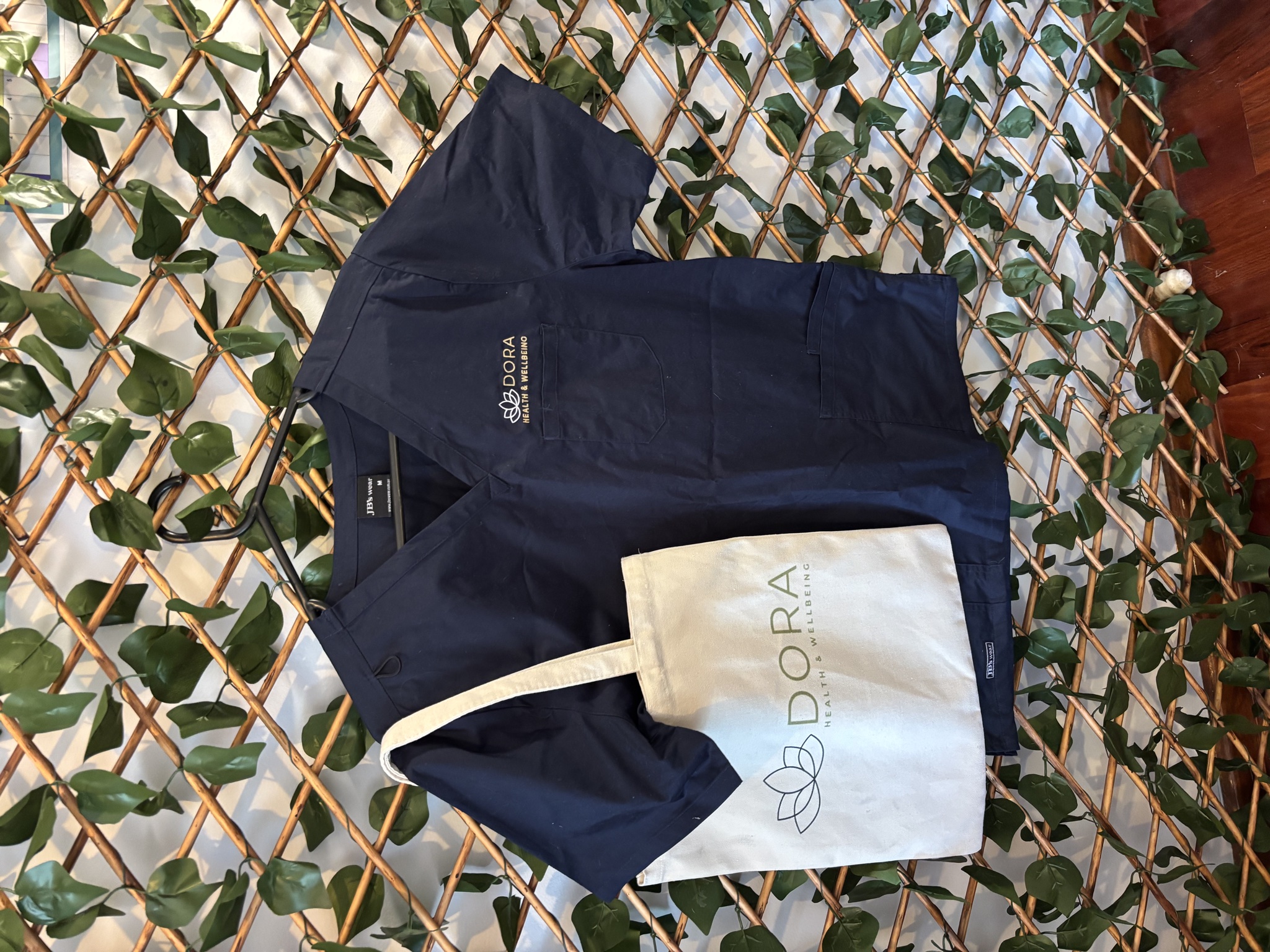 Dora Health & Wellbeing scrubs and branded tote